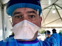 Male nurse in protective gear.